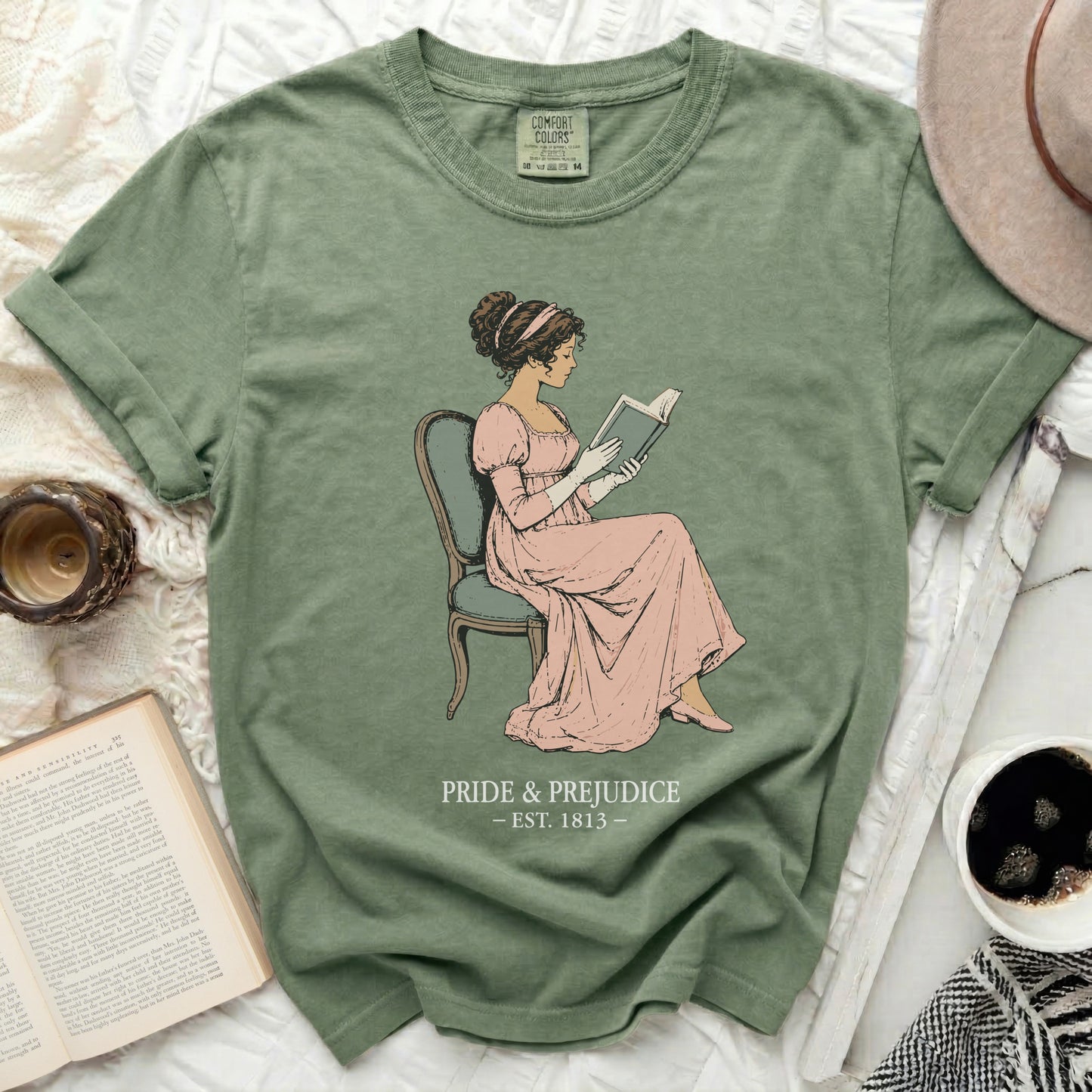 Green t-shirt with "Pride & Prejudice - Est. 1813" and a drawing of a woman reading.