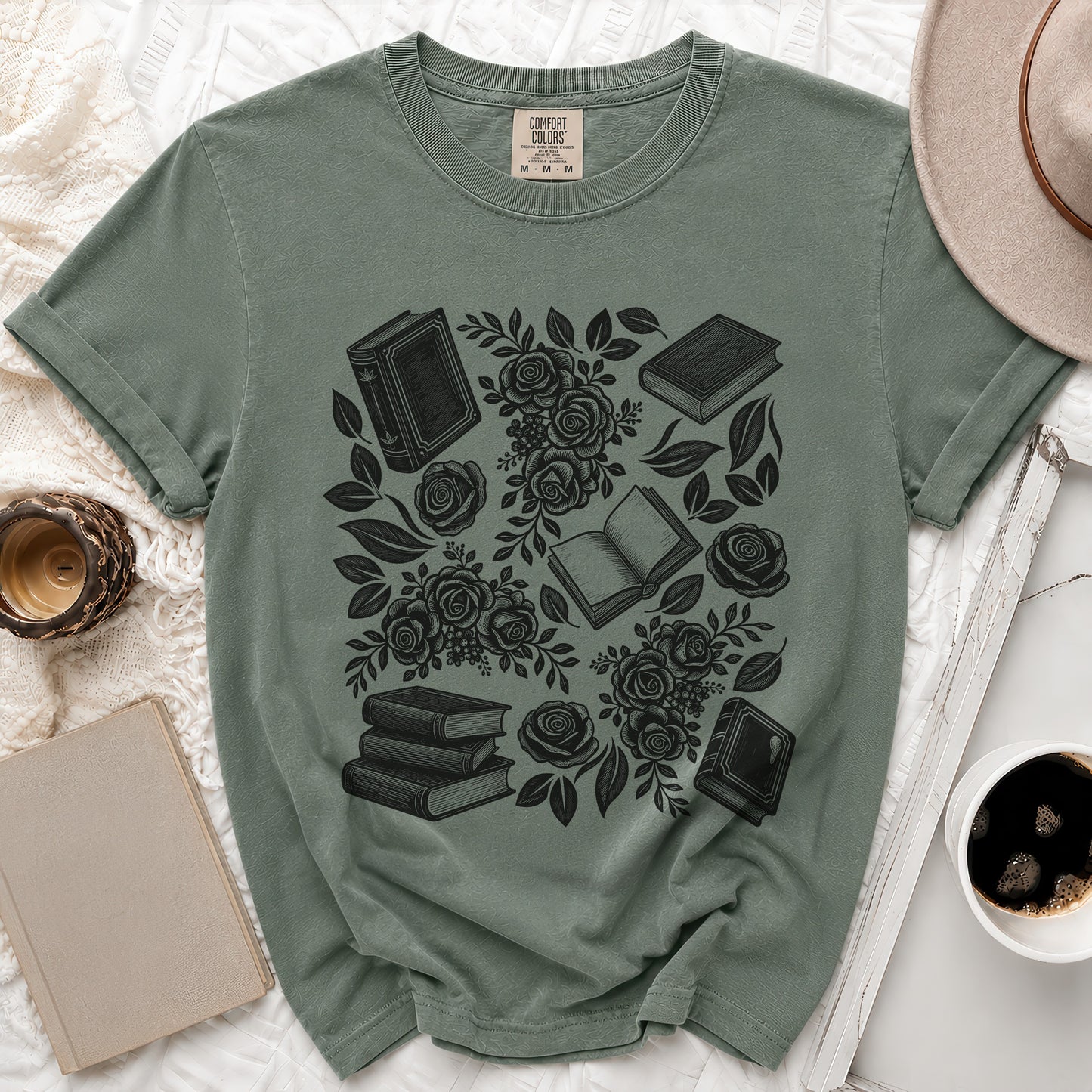 Sage green t-shirt with black print of books and roses, size medium.