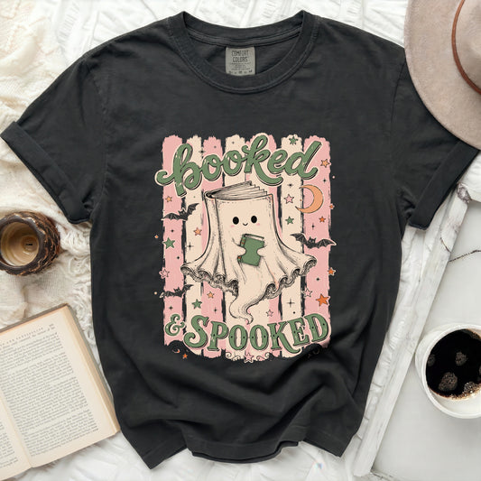 Booked & Spooked graphic tee with ghost reading a book, bats, and moon.