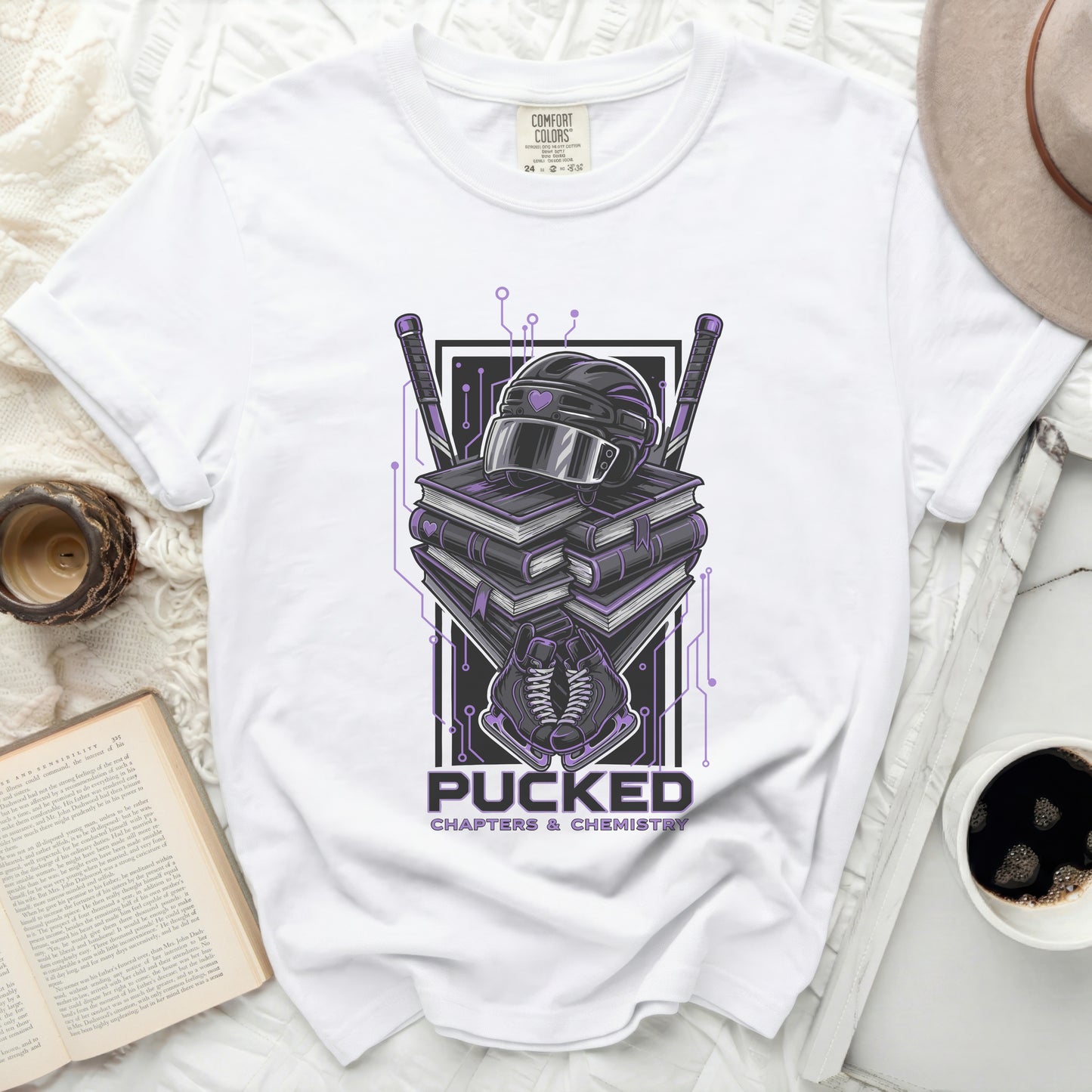 White t-shirt with "Pucked Chapters & Chemistry" text and hockey gear graphic.