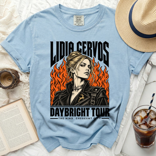 Light blue t-shirt with "Lidia Cervos Daybright Tour" graphic and fiery background.