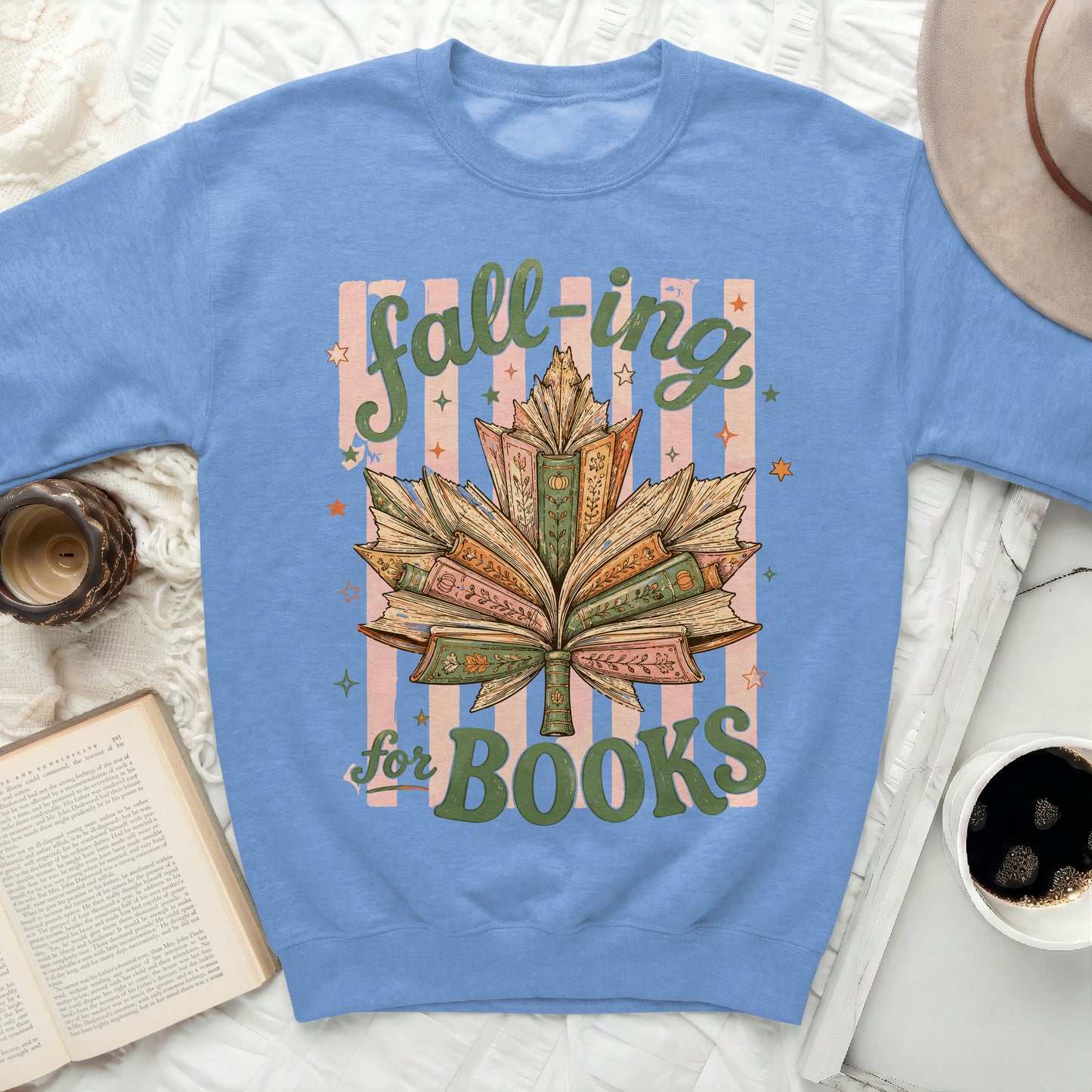 Sweatshirt with open books forming a leaf and text "fall-ing for BOOKS".
