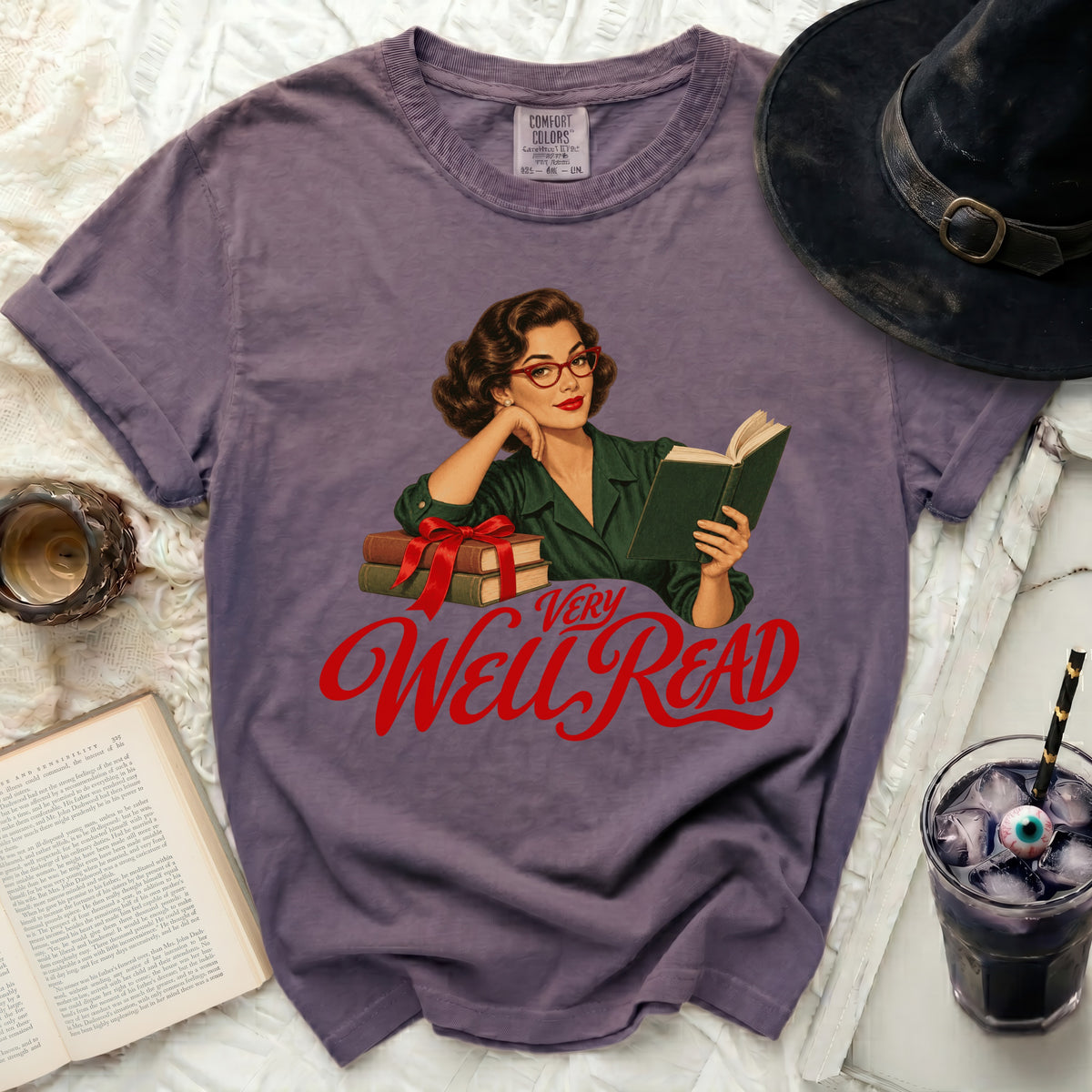 Purple t-shirt with retro woman illustration and "Very Well Read" text.
