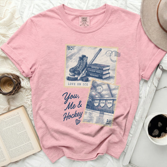 Pink t-shirt with vintage hockey stamp design and text "You, Me & Hockey".