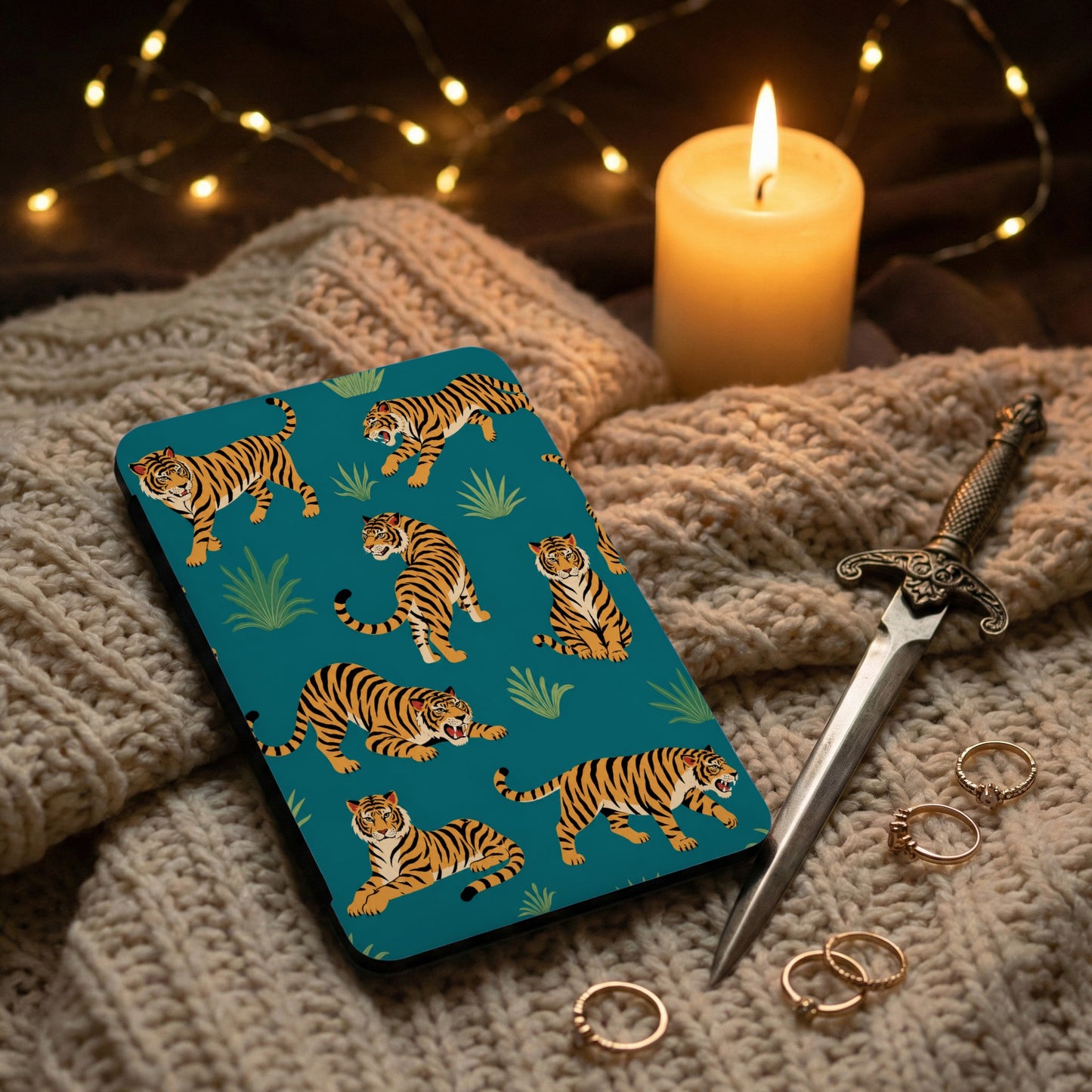 Phone case with multiple tigers and jungle leaves on a teal background.