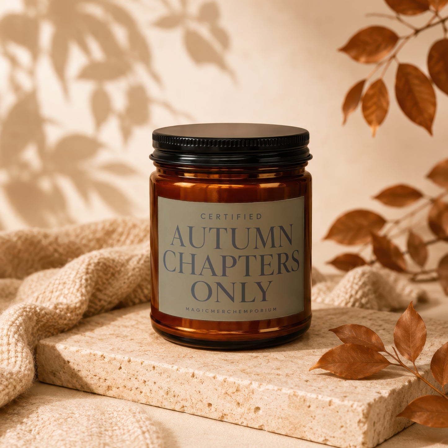 Amber jar candle with black lid, label reads "Certified Autumn Chapters Only".