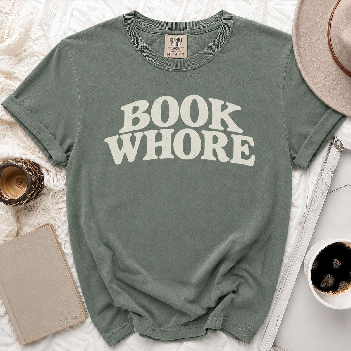 Sage green t-shirt with "BOOK WHORE" text in cream vintage font.