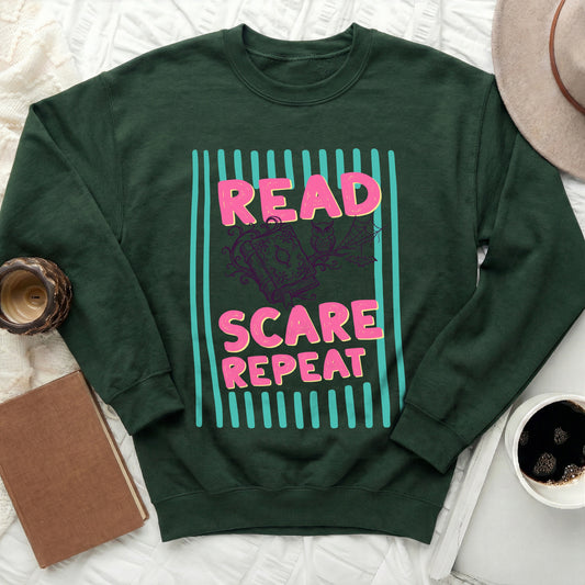 Green sweatshirt with "READ SCARE REPEAT" text and Halloween graphic.