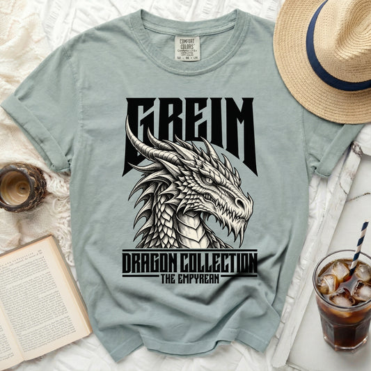 A light blue t-shirt with a black dragon design and "FREIM DRAGON COLLECTION THE EMPYREAN" text.