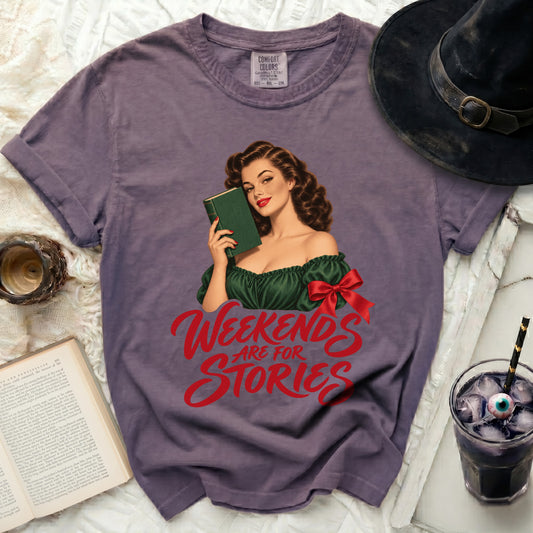 Purple t-shirt with vintage illustration of a woman reading and "Weekends Are For Stories" text.