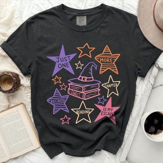 Black t-shirt with wizard hat, books, and stars graphic reading "Just One More Chapter Because Reading Is My Escape".