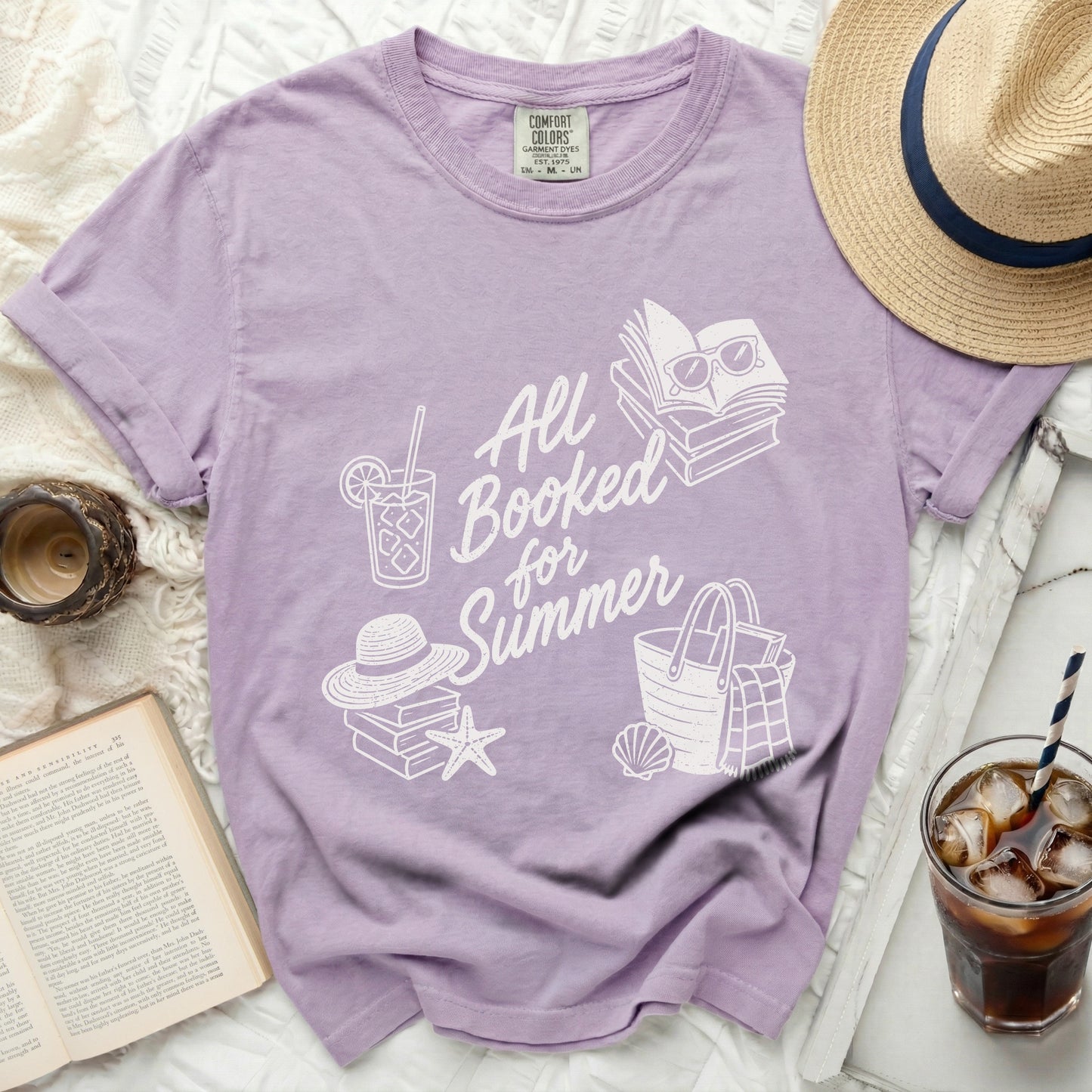 Purple t-shirt with "All Booked for Summer" text and beach graphics.
