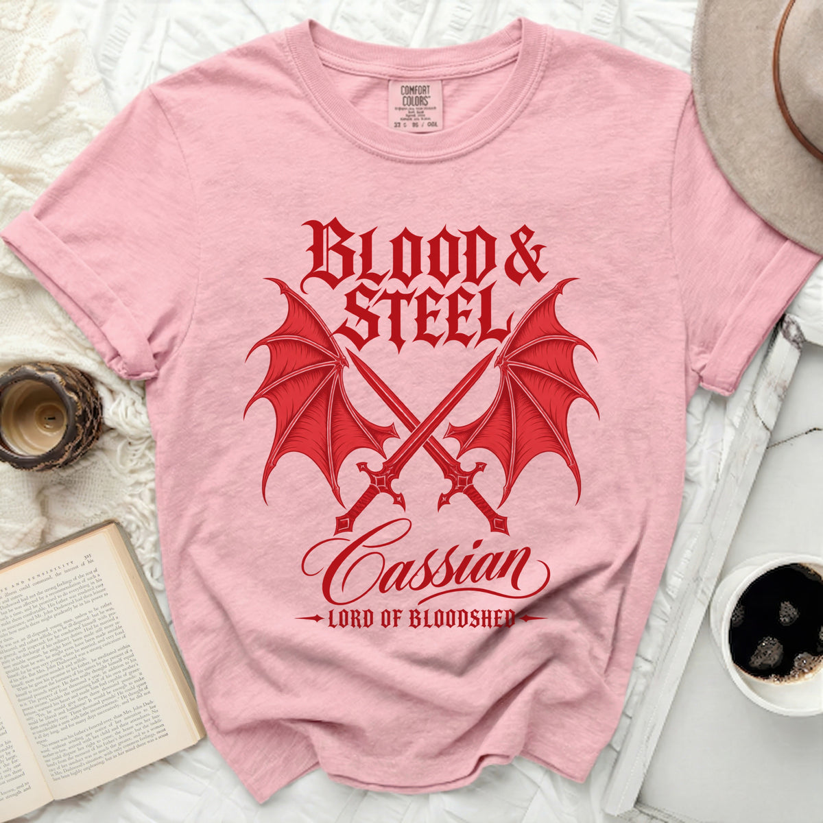 Pink t-shirt with red "Blood & Steel Cassian Lord of Bloodshed" graphic.