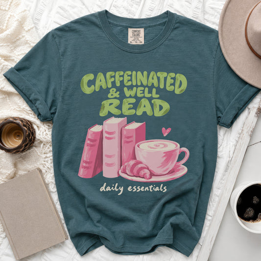 Teal t-shirt with "Caffeinated & Well Read daily essentials" text and graphic.