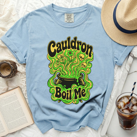 Light blue t-shirt with "Cauldron Boil Me" graphic and occult imagery.