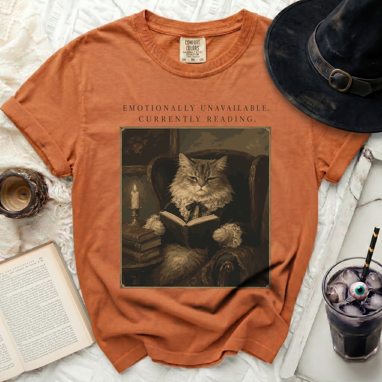 Orange t-shirt with "Emotionally Unavailable. Currently Reading." and a cat image.