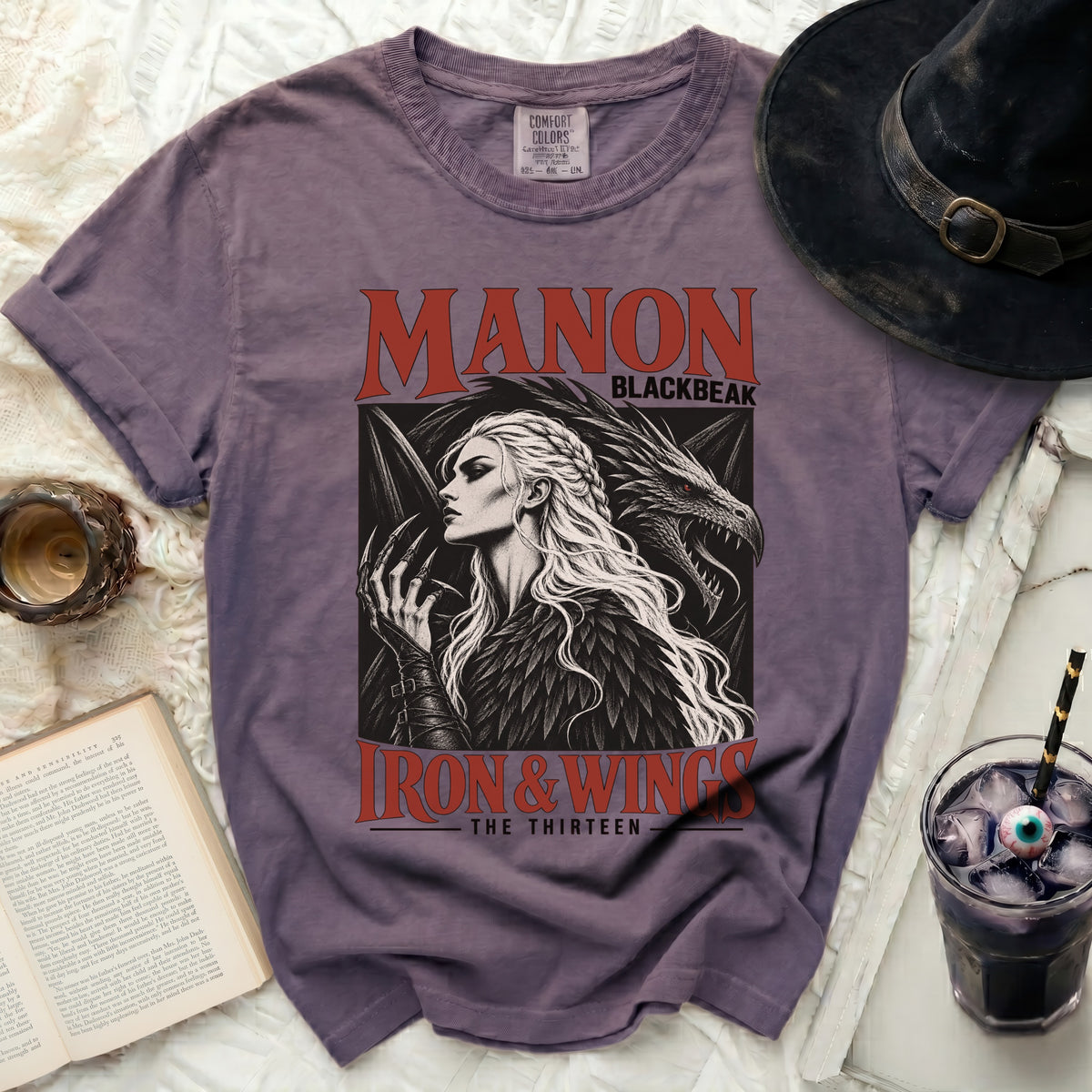 Purple t-shirt with "Manon Blackbeak Iron & Wings The Thirteen" text and dragon/woman graphic.