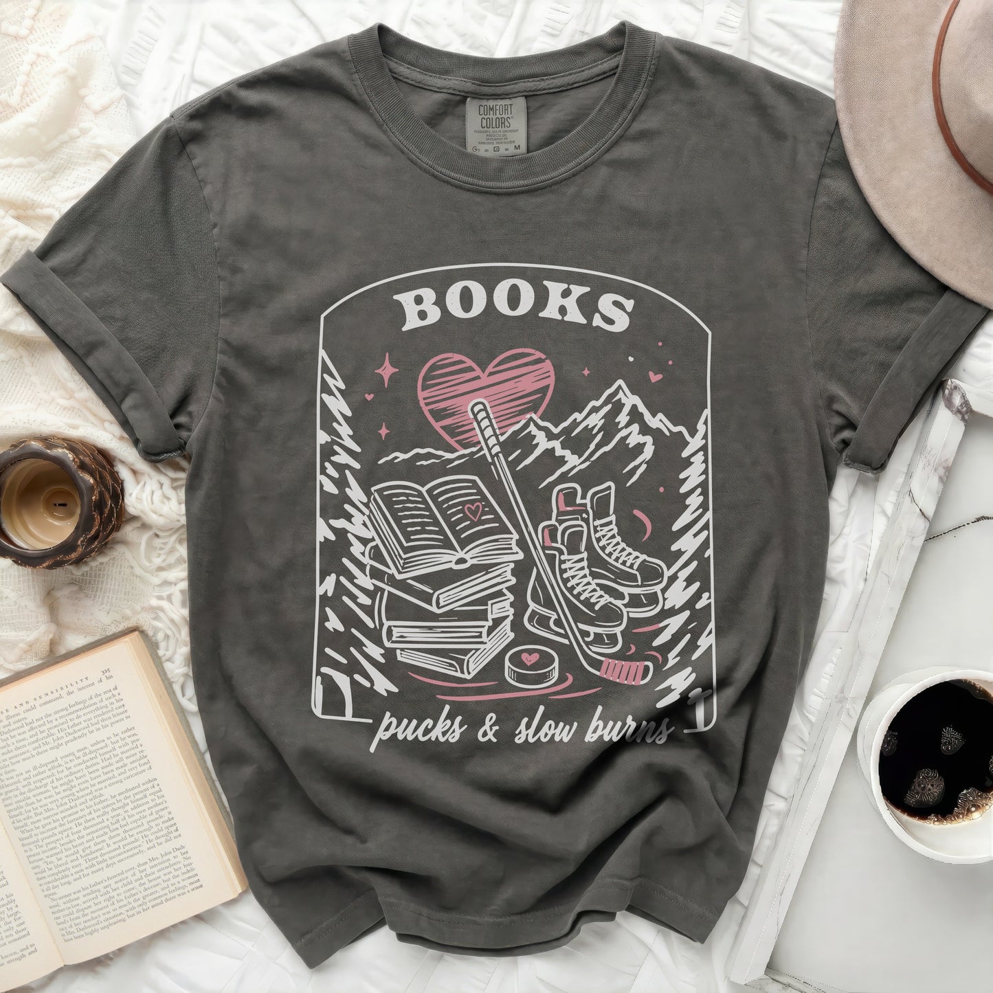 Dark grey t-shirt with "BOOKS pucks & slow burns" graphic.