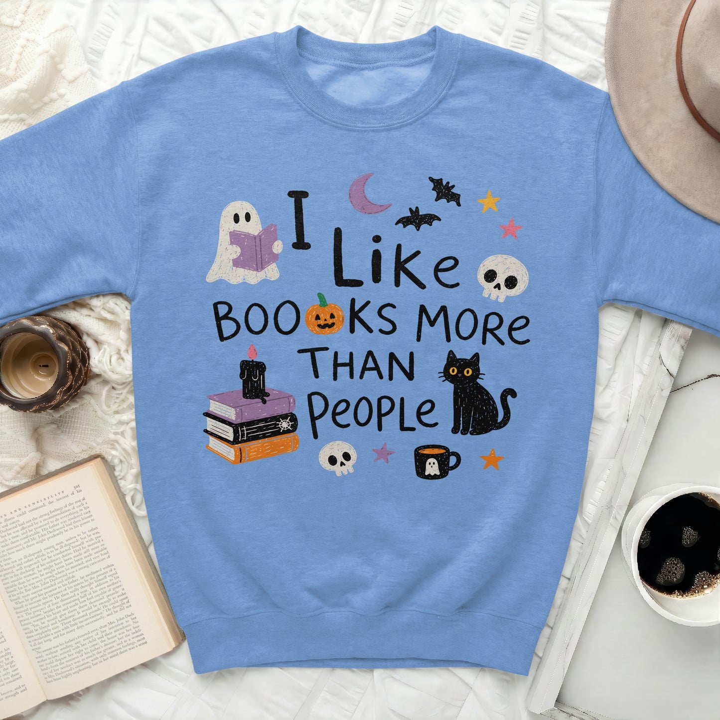 Light blue sweatshirt with "I Like Books More Than People" and Halloween graphics.