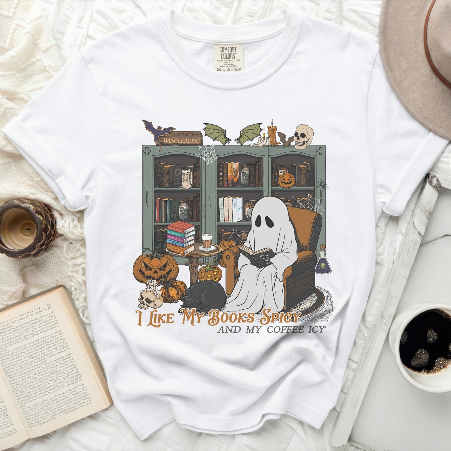 White t-shirt with "I Like My Books Spicy And My Coffee Icy" Halloween graphic.