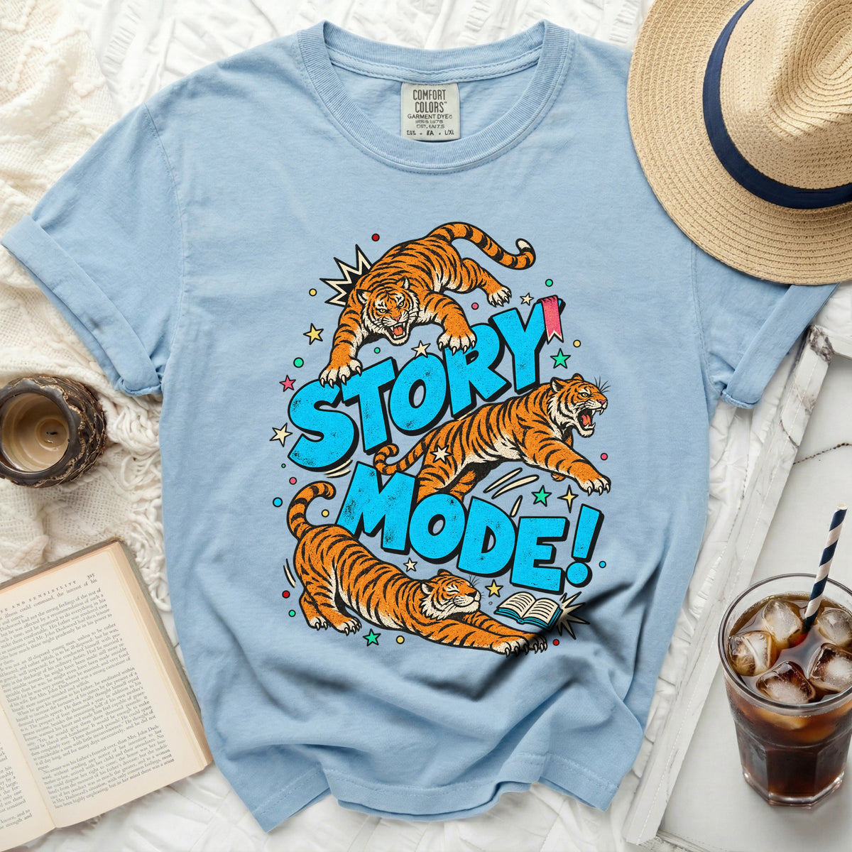 Light blue t-shirt with graphic of three tigers and text "STORY MODE!".