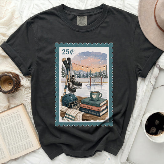 T-shirt with postage stamp graphic of ice hockey scene and books.