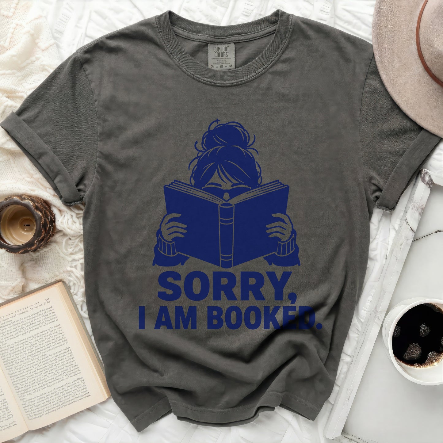 Dark grey t-shirt with blue text reading "SORRY, I AM BOOKED."