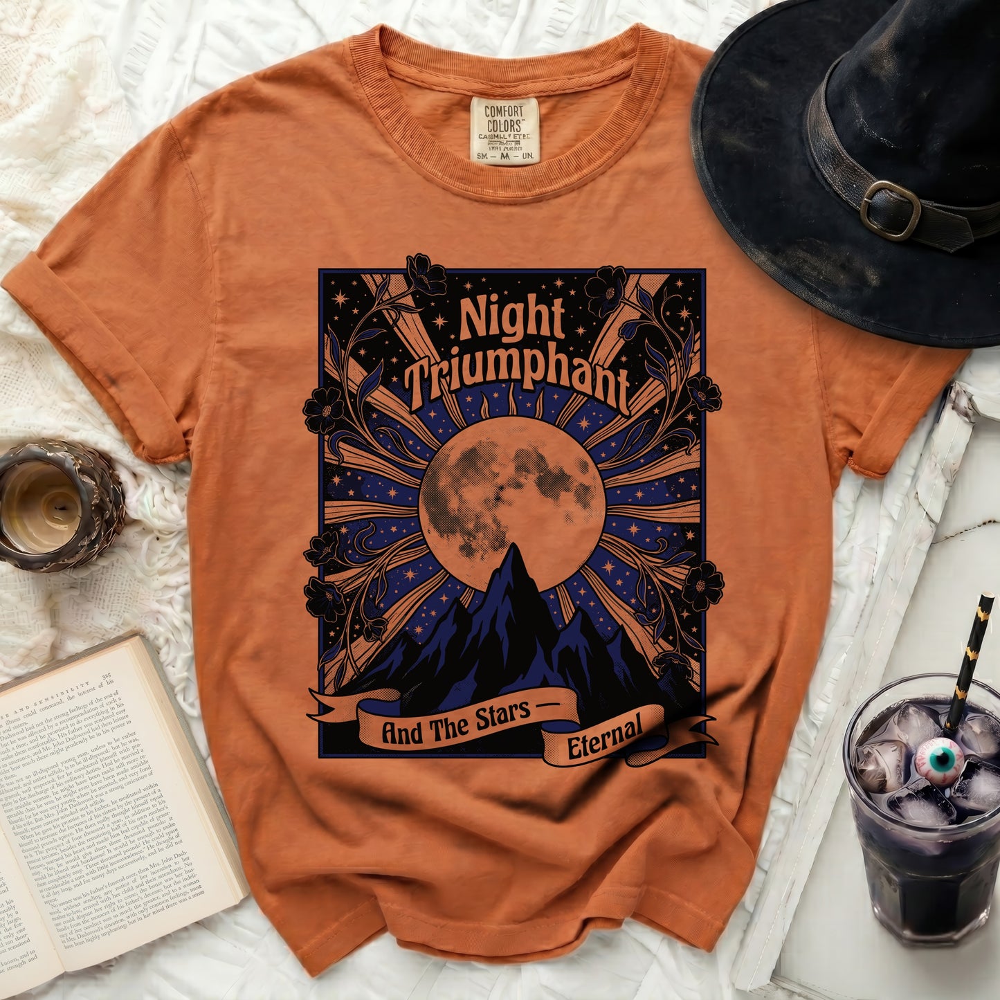 Orange t-shirt with "Night Triumphant And The Stars Eternal" graphic.