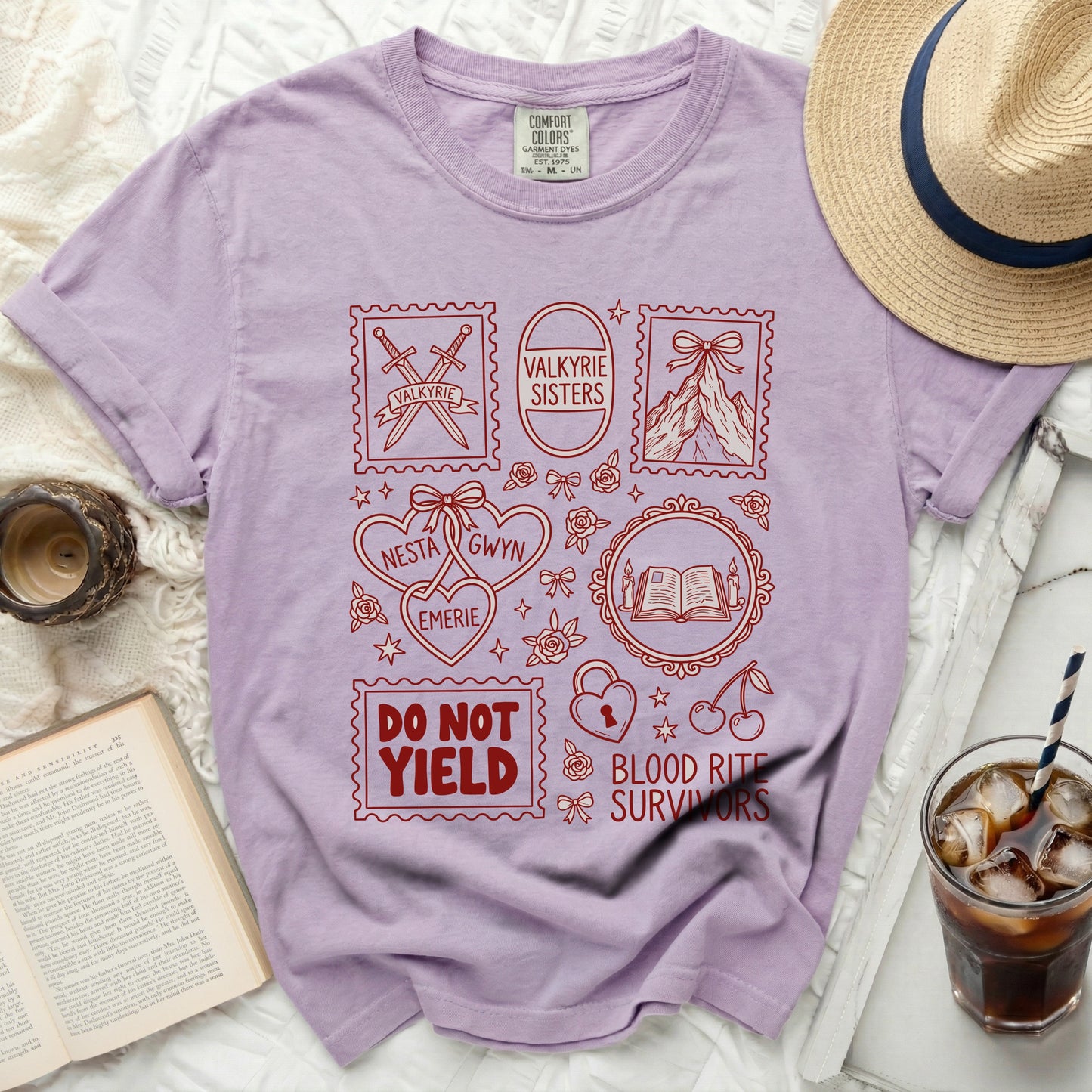 Lavender t-shirt with red graphic of stamps, books, and text.