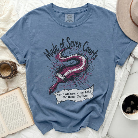 Blue t-shirt with "Made of Seven Courts" and paint brush design.