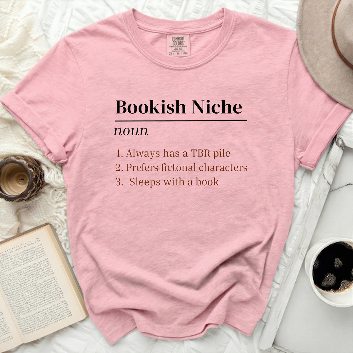 Pink t-shirt with "Bookish Niche" definition and reading-themed list.