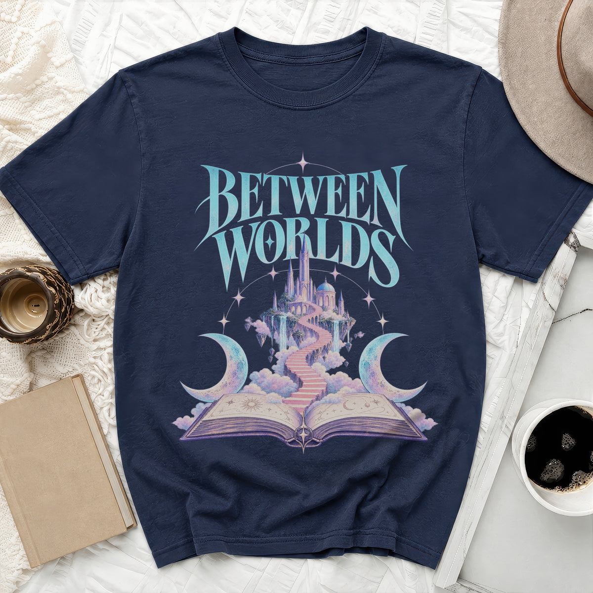 Navy t-shirt with "BETWEEN WORLDS" text and fantasy castle design.