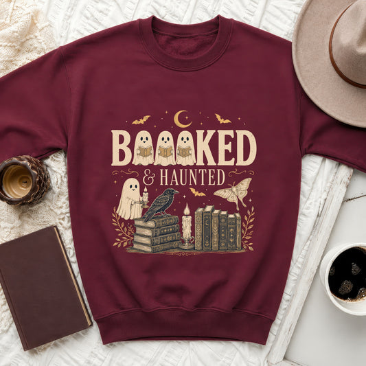 Maroon sweatshirt with the text "BAAAKED & HAUNTED" featuring ghosts and books.