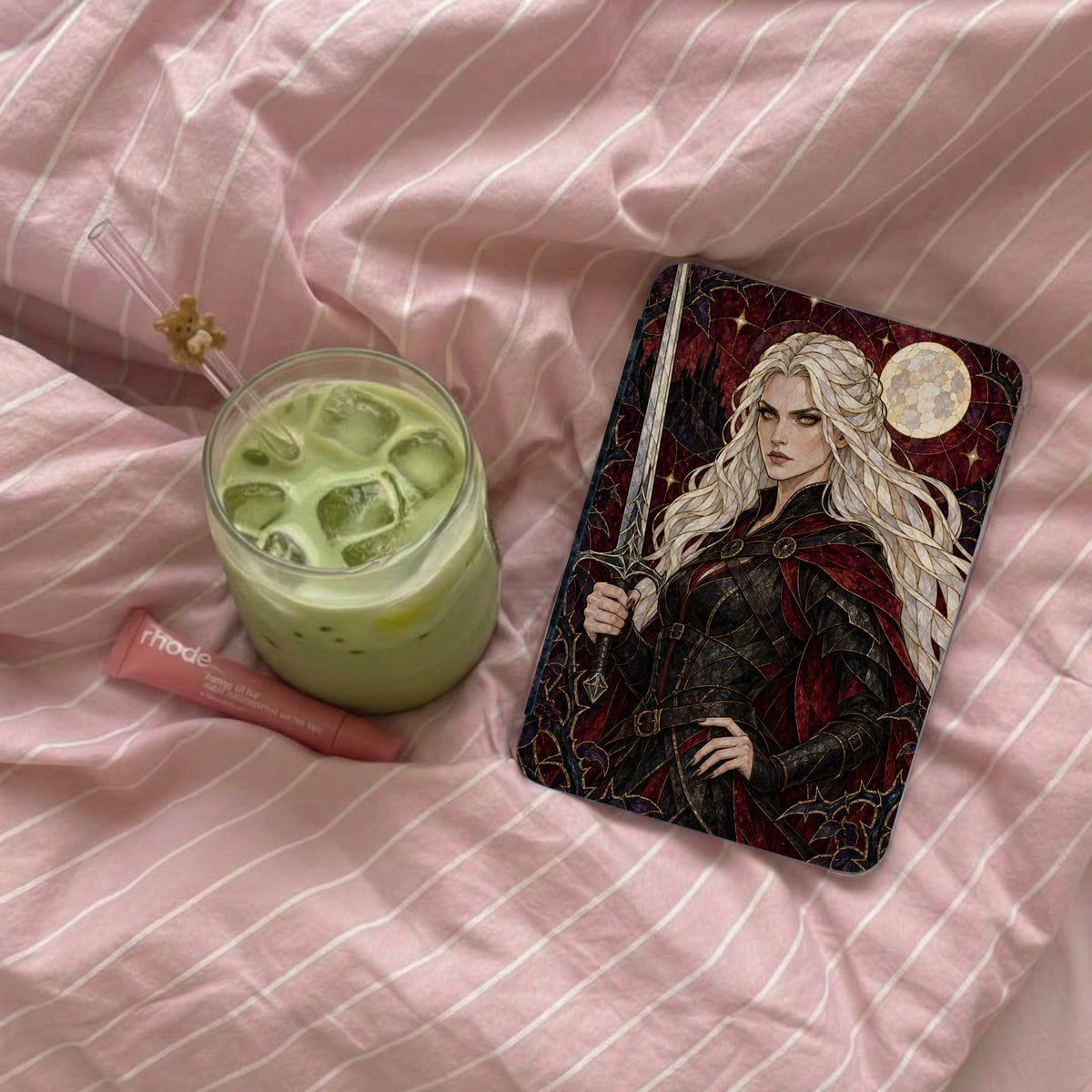 Phone case featuring a woman with long white hair, sword, and moon on a pink striped background.