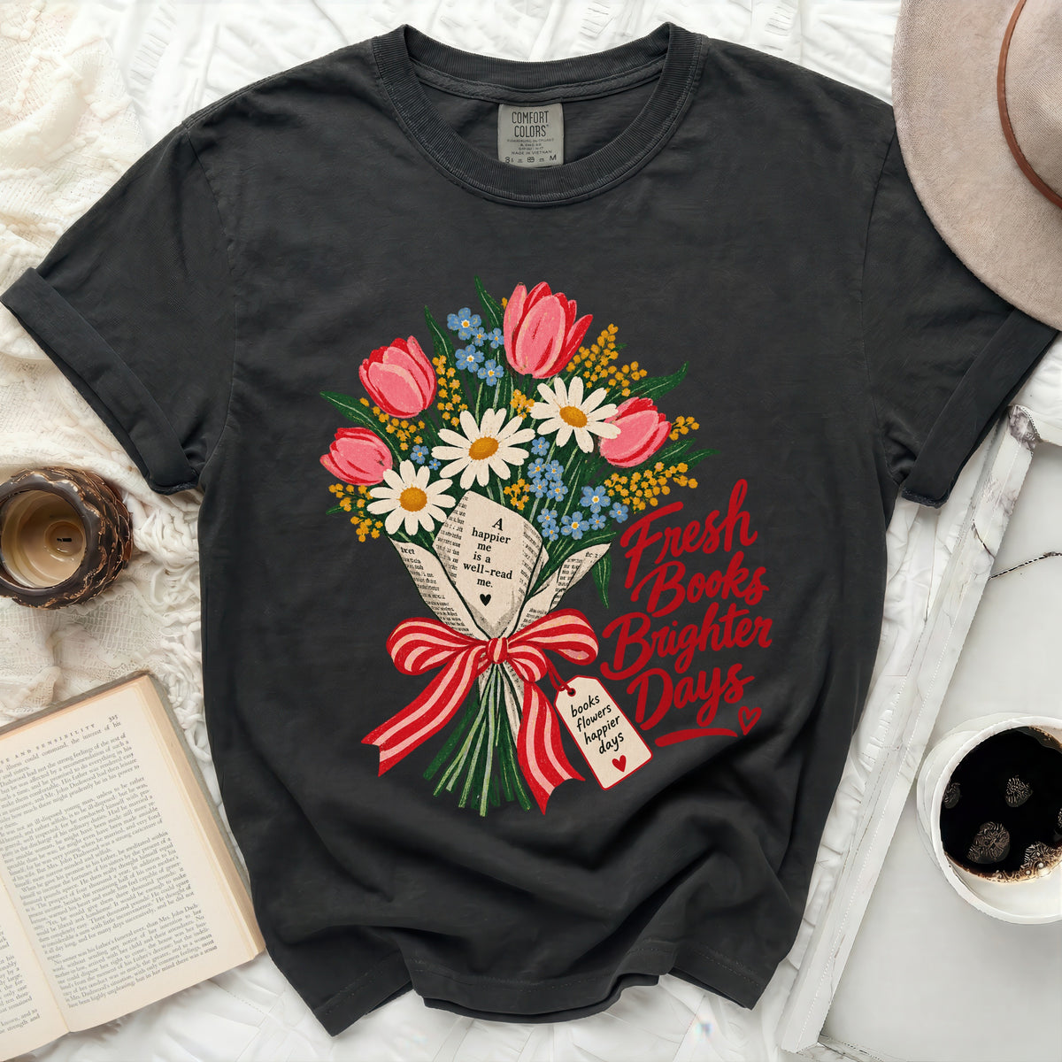 Dark t-shirt with floral bouquet and "Fresh Books Brighter Days" text.