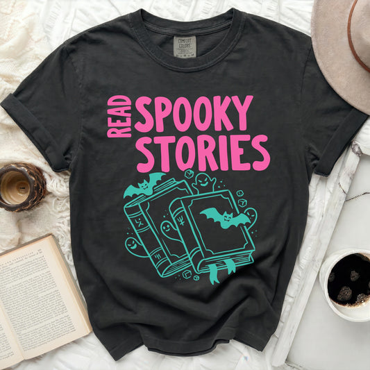 Dark t-shirt with "Read Spooky Stories" in pink and teal graphics.