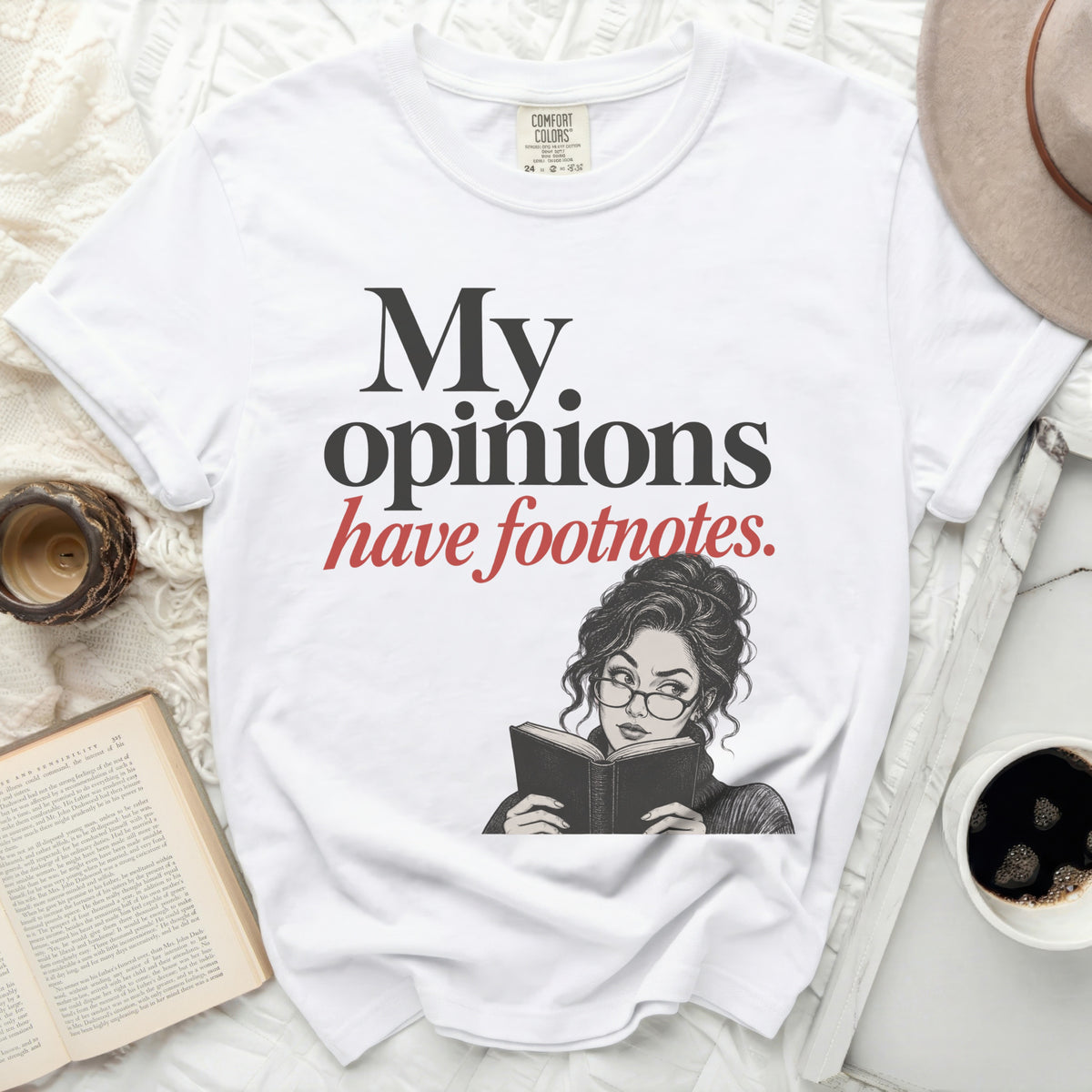 White t-shirt with "My opinions have footnotes." text and illustration.
