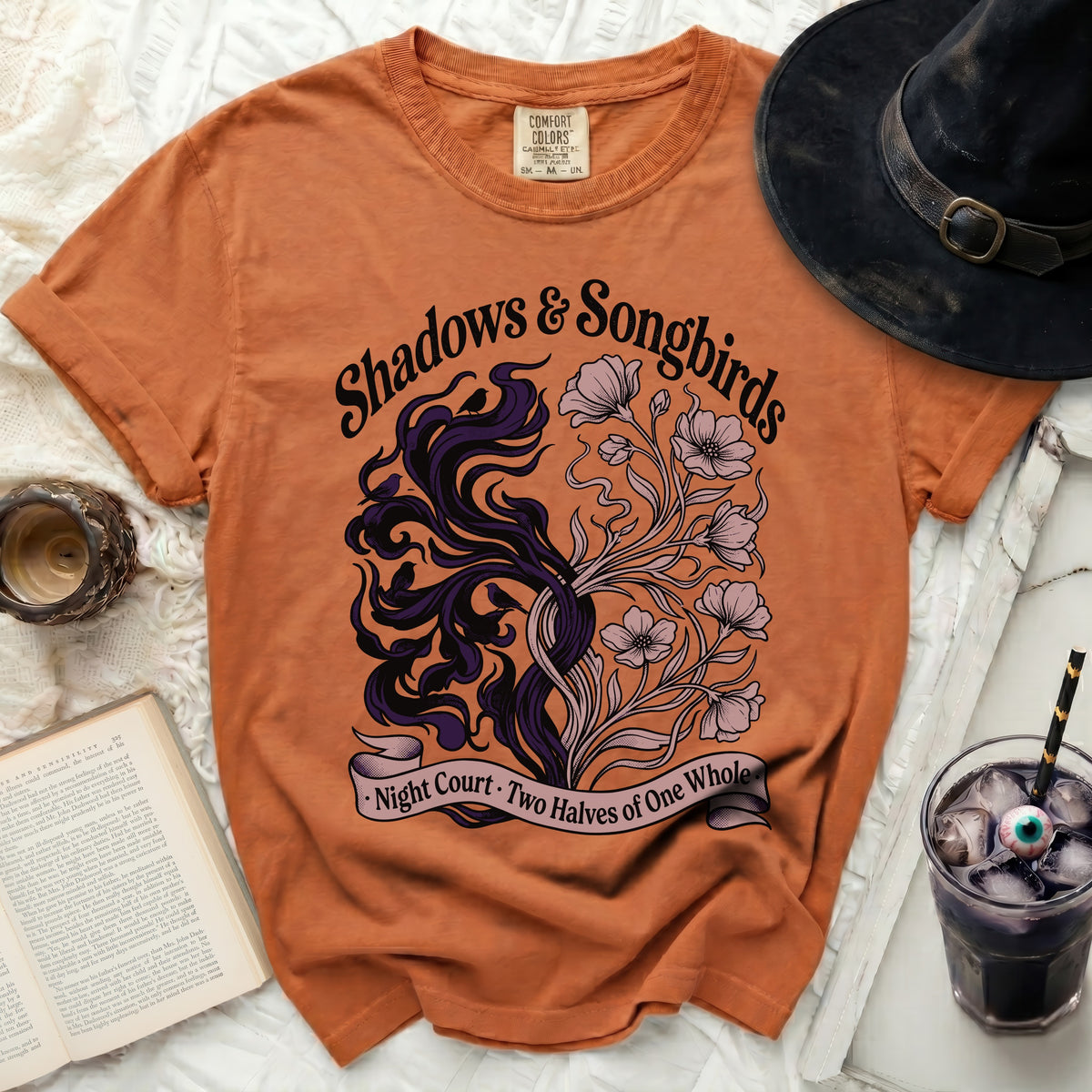 Orange t-shirt with "Shadows & Songbirds" text and intricate design.