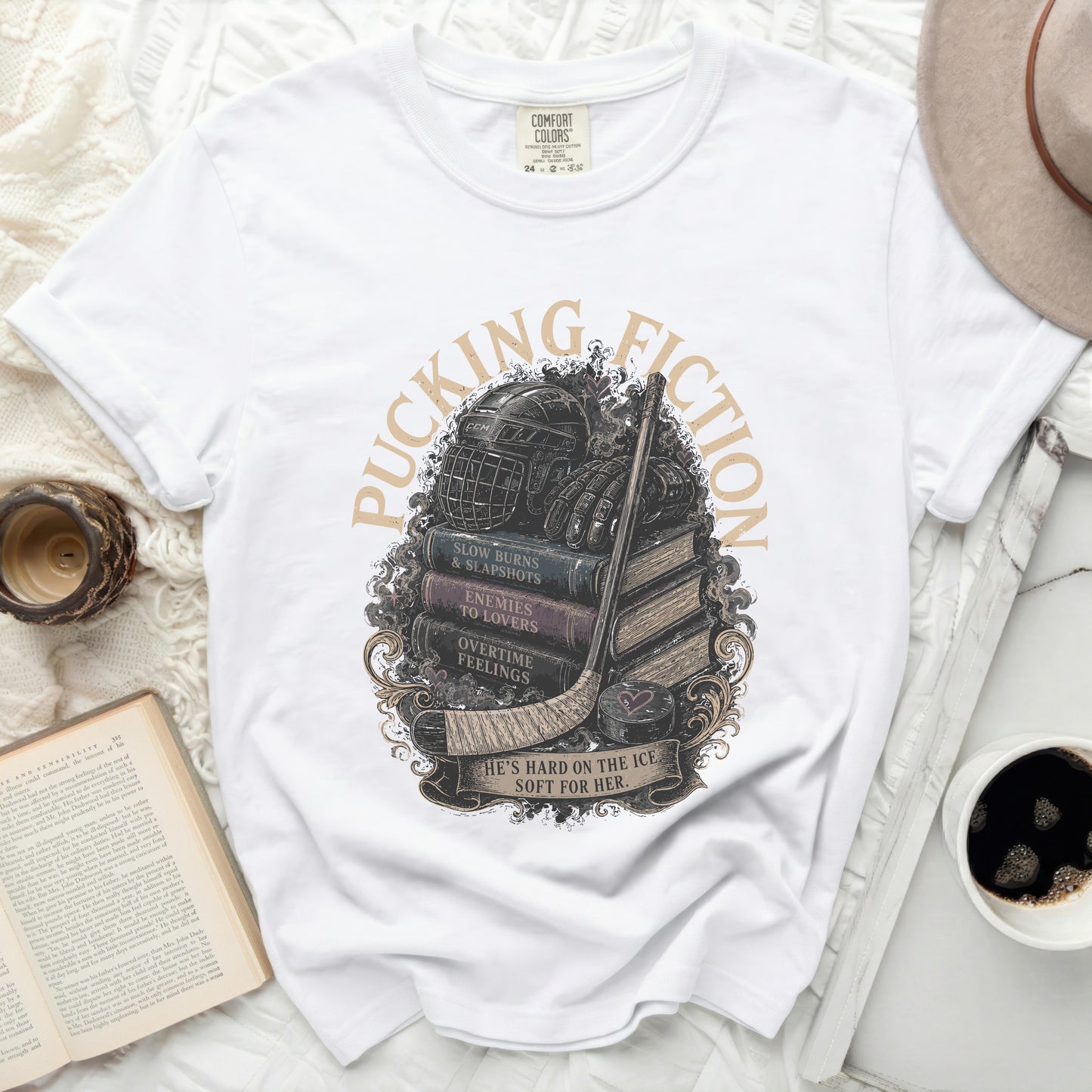 White t-shirt with hockey equipment on stacked books and distressed text.