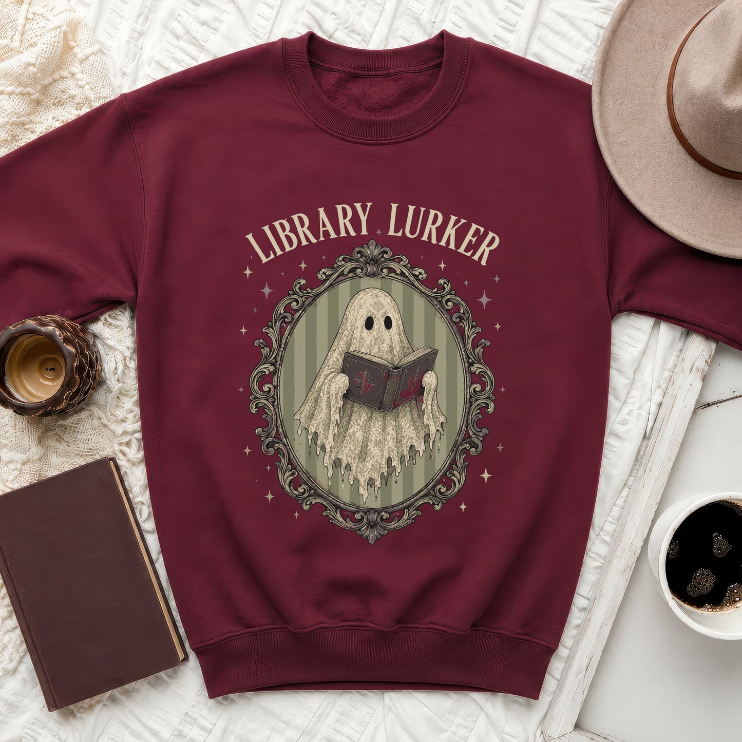 Maroon sweatshirt with "Library Lurker" text and ghost reading a book.