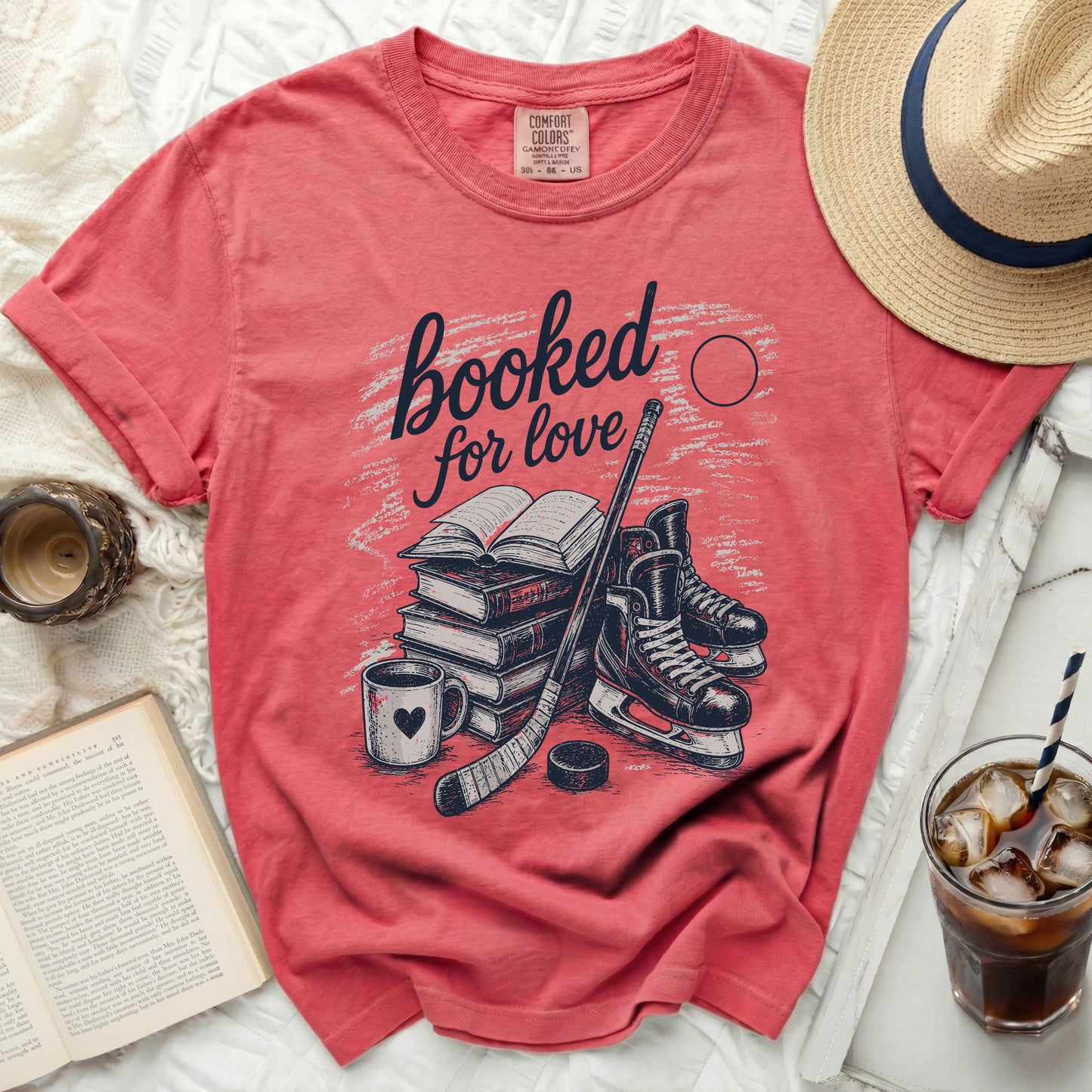 Coral t-shirt with "booked for love" text and hockey illustration.