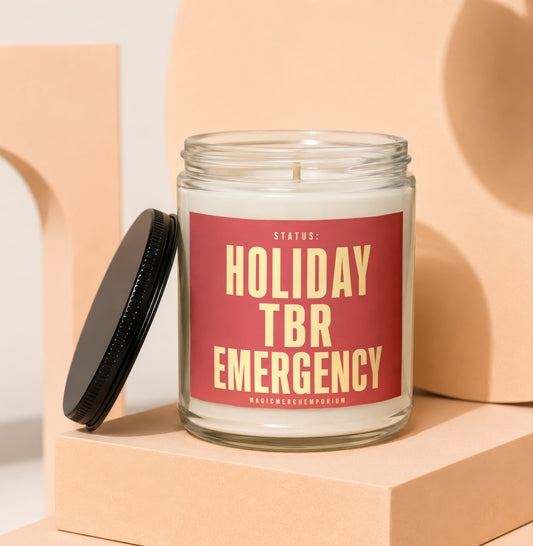 Glass candle with red label reading "STATUS: HOLIDAY TBR EMERGENCY"
