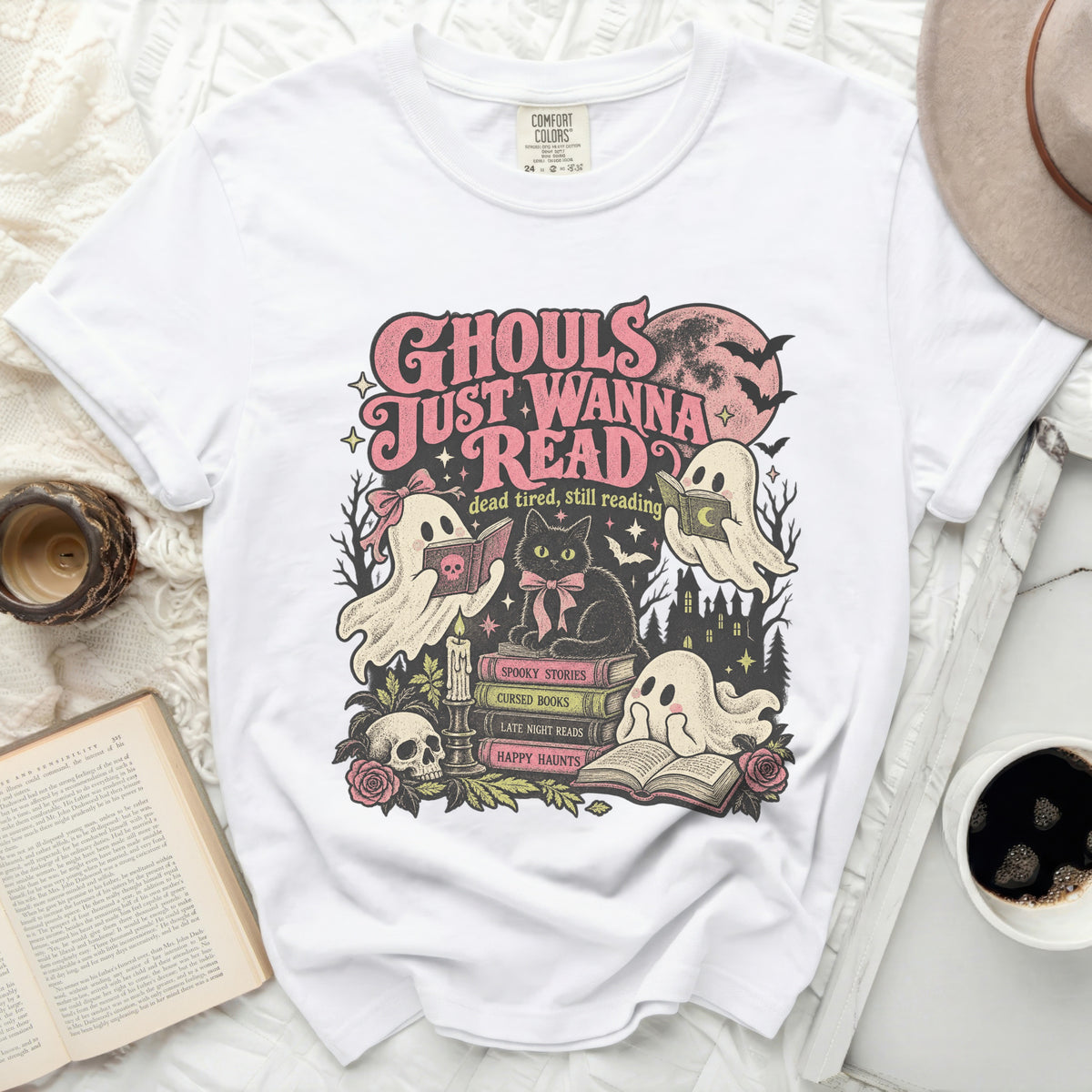 White t-shirt with "Ghouls Just Wanna Read" graphic featuring ghosts, a cat, books, and Halloween elements.
