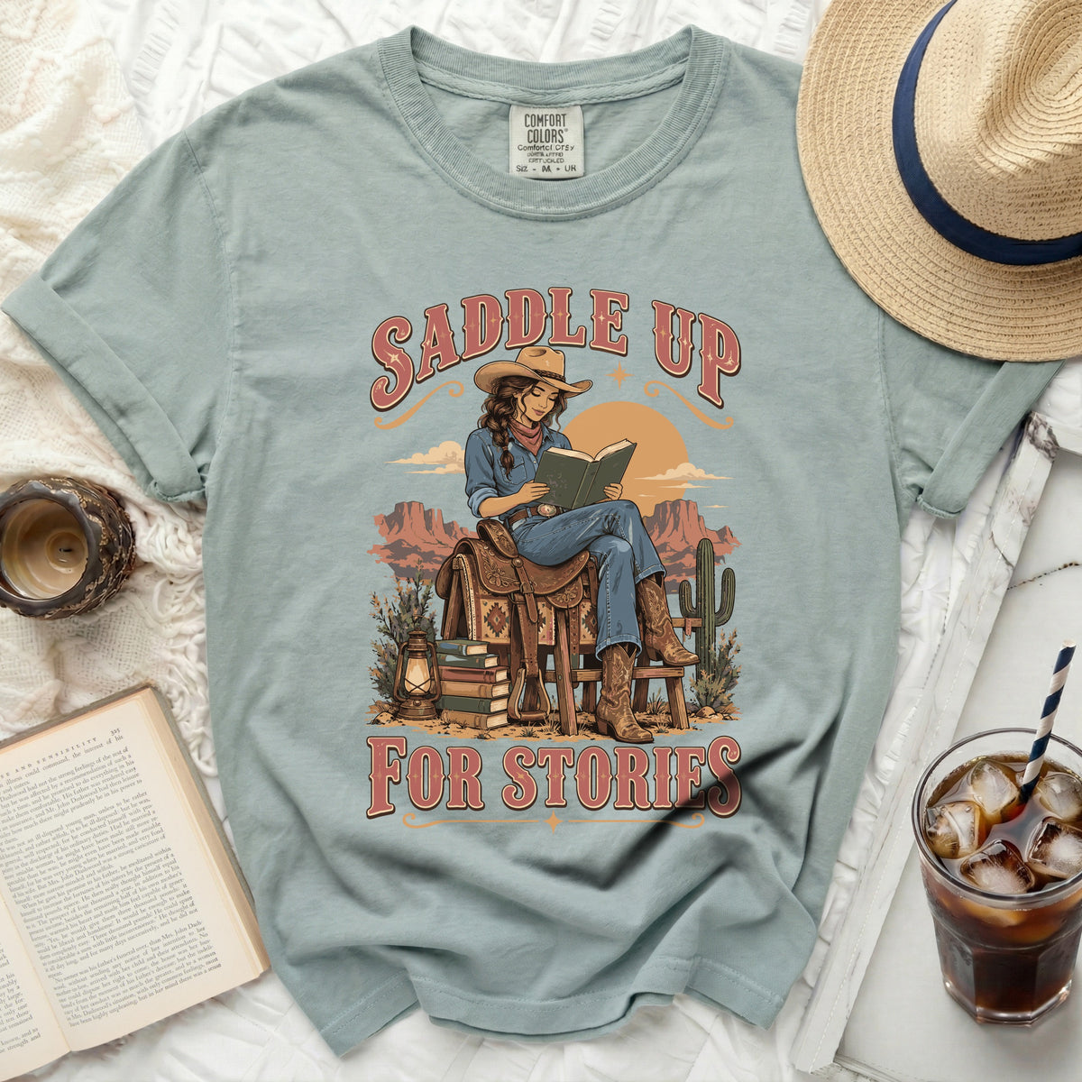 Cowgirl reading a book on a saddle, with text "SADDLE UP FOR STORIES".