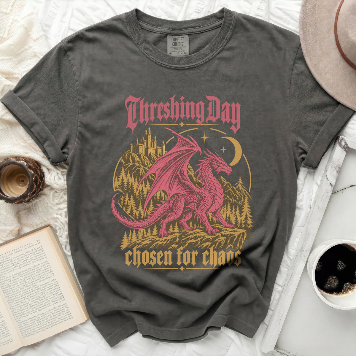 Graphic t-shirt with a pink dragon, castle, and trees. Text reads "Threshing Day chosen for chaos".
