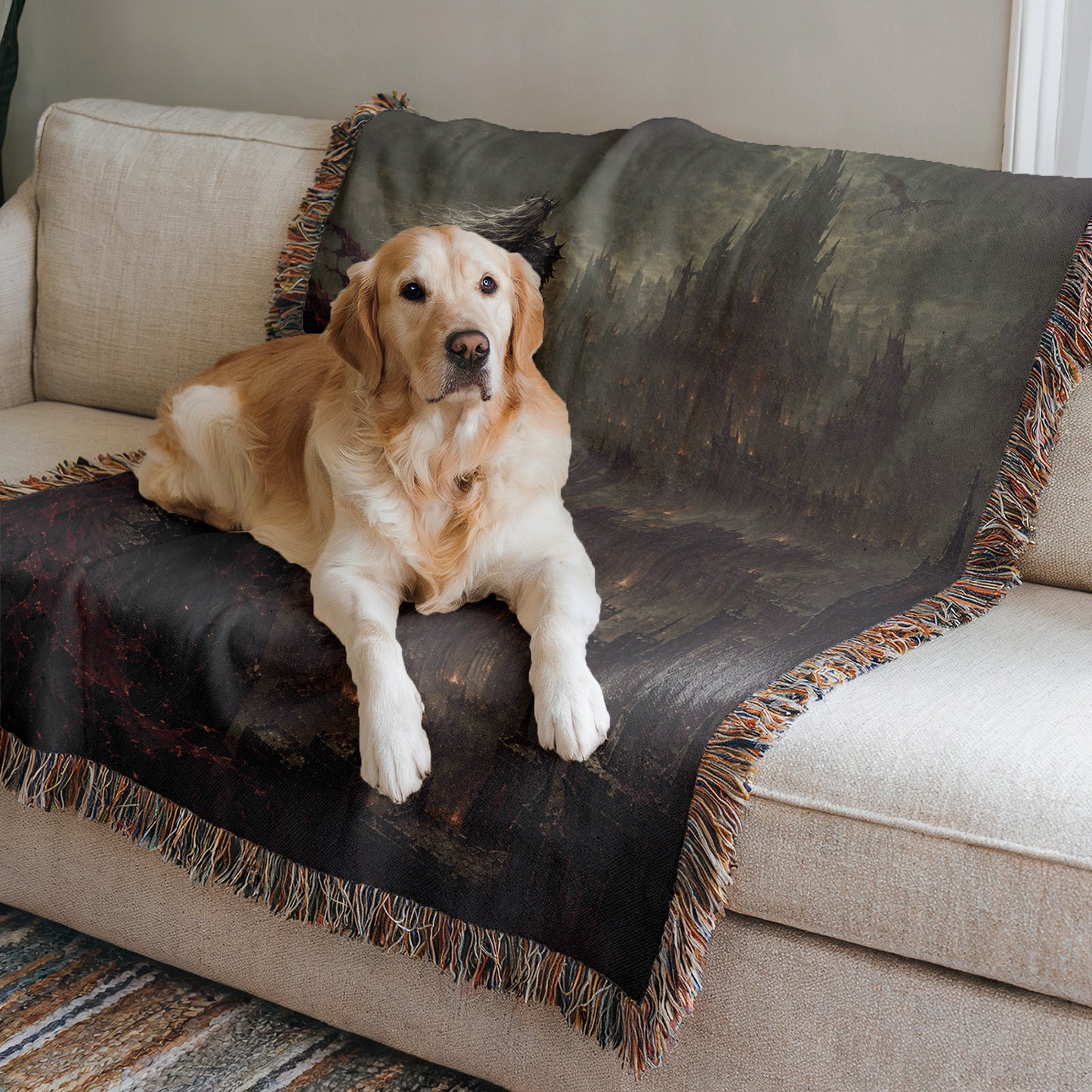 A golden retriever dog is lying on a black and gray throw blanket on a beige couch.
