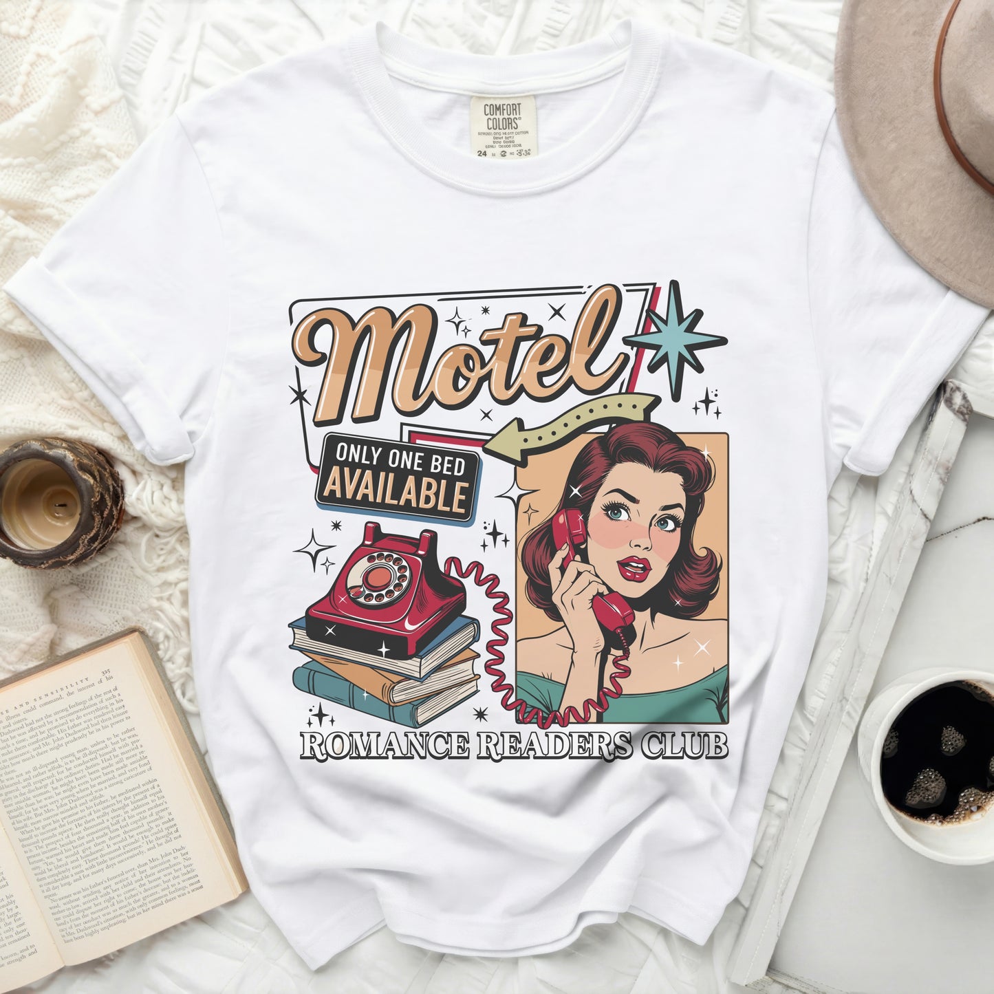 White t-shirt with vintage "Motel Only One Bed Available" graphic and woman on phone.