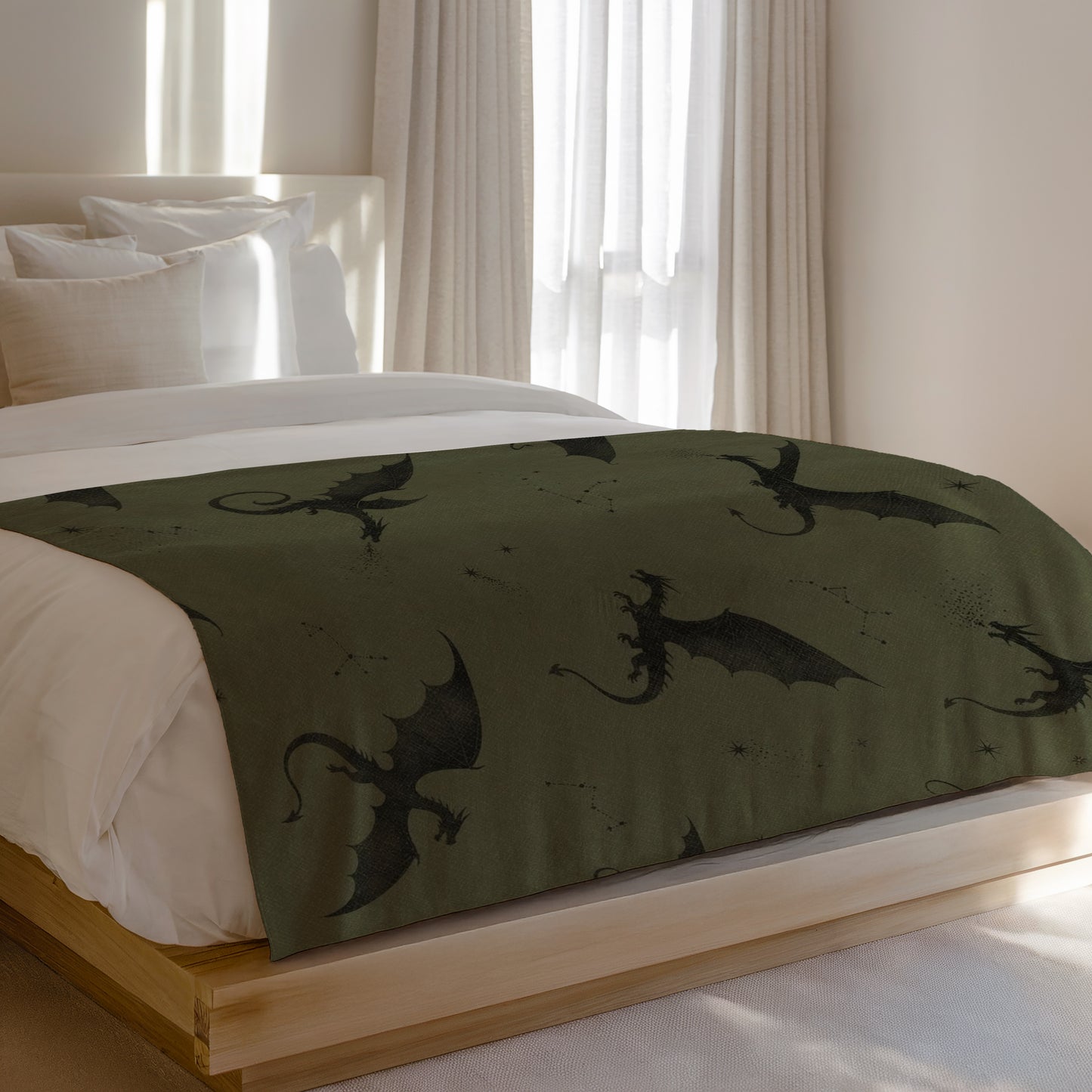 Bed runner with black dragon and constellation pattern on green fabric.