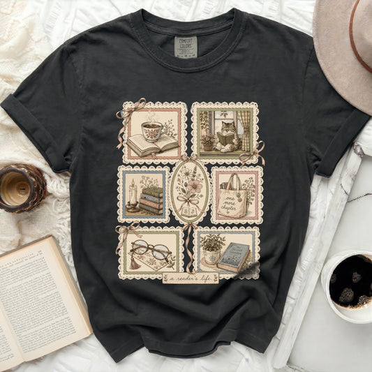 Black t-shirt with embroidered book and tea motifs and "a reader's life" text.