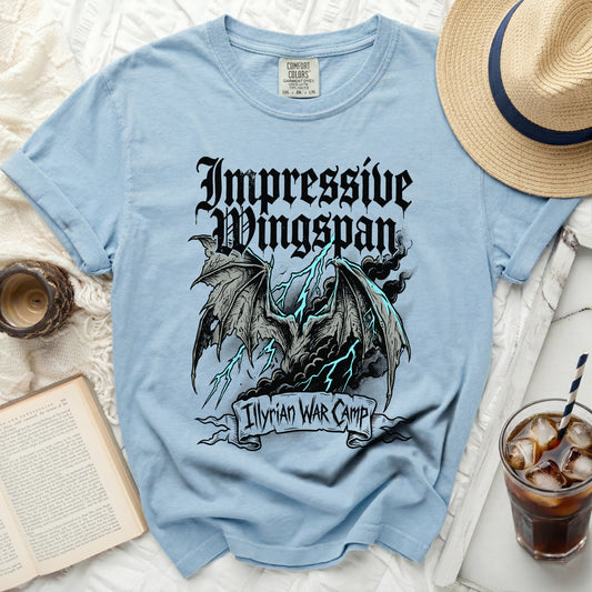 Light blue t-shirt with "Impressive Wingspan" and "Illyrian WAR CAMP" graphic.